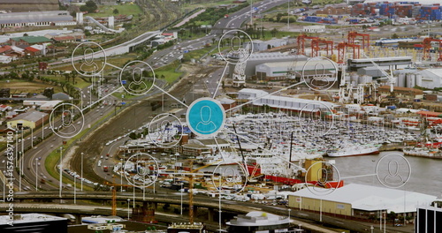 Displaying central blue network node connecting containers, cranes and ships at industrial port