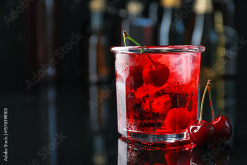 Wallpaper Mural Tasty cherry soda water with ice cubes and berries in glass on mirror table against blurred background, closeup. Space for text Torontodigital.ca