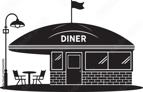 Classic american diner building with outdoor seating and street lamp silhouette