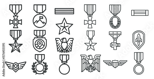 Collection of military medals and awards. The medals are all in black and white. The medals are arranged in a row, with some of them overlapping each other. The medals are of various shapes