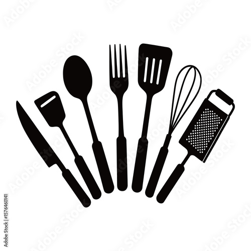 Metal kitchen cutlery and cooking tools, including a fork, spoon, knife, and spatula, isolated on white