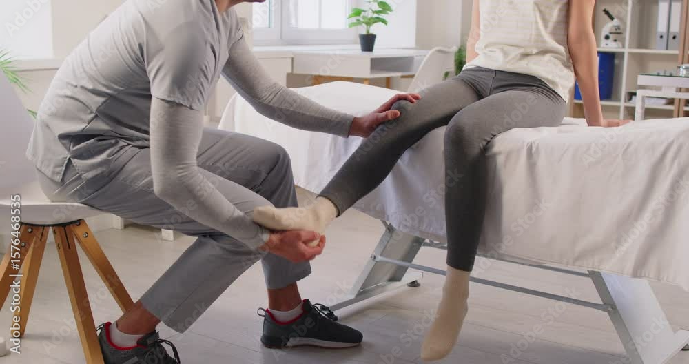 Male therapist provides rehabilitation and physiotherapy exercise, massaging a patient legs and knee joints. Physical stretching, recovery, and improving mobility through expert treatment.