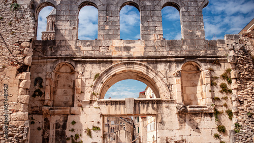 Ancient Golden Gate (Porta Aurea) of Diocletian's Palace in Split, Croatia. Roman architecture and old stone wall under a bright blue sky, viewed from inside the city.