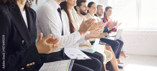 Foto Cropped view of professional team sitting in row in conference room, applauding to speaker