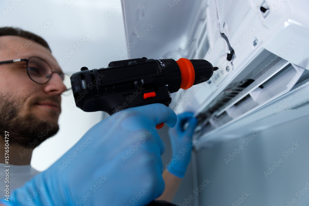Expert Technician Performing Maintenance on an Air Conditioning Unit with a Power Drill for Efficient Service Excellence and Quality Assurance in Indoor Environments Expert Technician Performing Maintenance on an Air Conditioning Unit with a Power Drill for Efficient Service Excellence and Quality Assurance in Indoor Environments