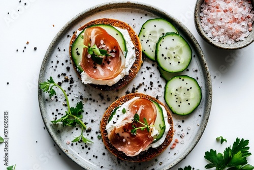 Delicious Open-Faced Sandwiches Topped With Cucumber and Prosciutto Garnished...