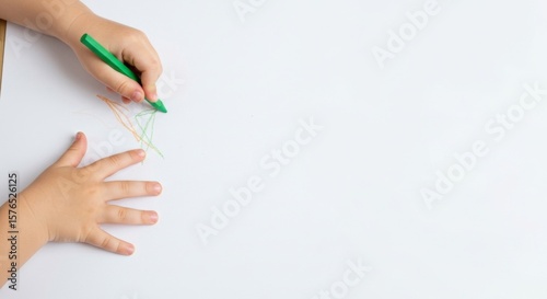 Child's Hand Drawing with Green Crayon on White Paper, Creative and Artistic Concept