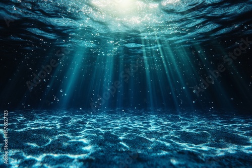 Underwater Light Rays Illuminate Sandy Ocean Floor in a Tranquil Setting