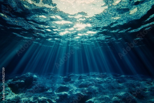 Underwater Light Rays Illuminate Sandy Ocean Floor in a Tranquil Setting
