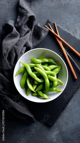 Fresh Edamame Served in a White Bowl With Chopsticks on a Dark Slate Surface ...