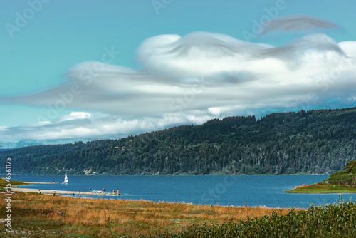 Clouds Rolling Over Humboldt Bay with Sailboat and Beachgoers