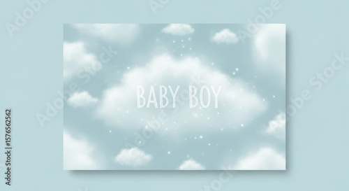 Baby boy announcement card with cloud background and text on a light blue wall in landscape orientation