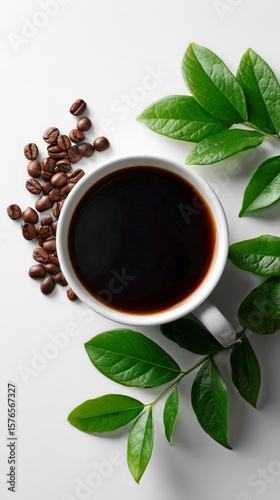 Rich Black Coffee in a White Cup Surrounded by Leaves and Coffee Beans