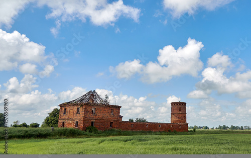 ruins of an old castle against a background of blue sky and clouds. Historical buildings in Belarus.