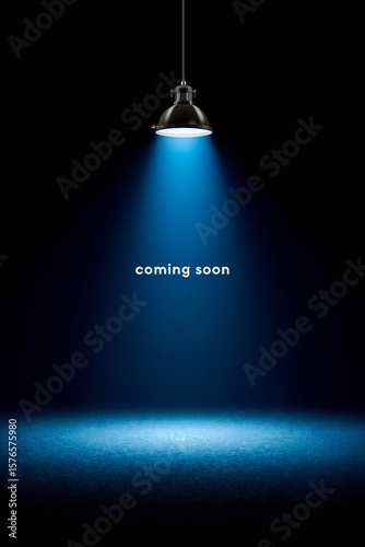 Spotlight shining on dark background with coming soon text.