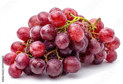 A cluster of red grapes, glistening with water droplets, rests on a white background.  The grapes are plump and appear ripe and juicy