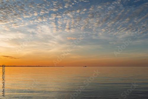 Wallpaper Mural Sunset over the sea. View from Morwong Beach across the bay, with Cleveland Point and a vehicular ferry on the horizon. Coochiemudlo Island, Queensland, Australia  Torontodigital.ca