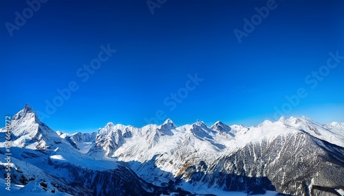 a snowy mountain range under a bright blue sky