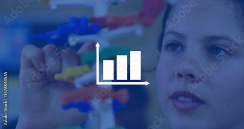 Student assembling molecular model in science lab, with colored connectors and rods, copy space