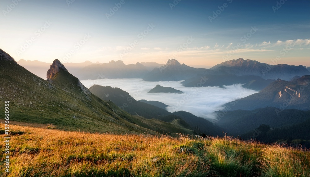 Obraz premium tranquil mountain vista with mist shrouded peaks evokes peace in a serene landscape captured in soft