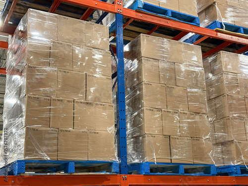 Pallets of boxes of wine stacked in distribution centre ready for shipment.