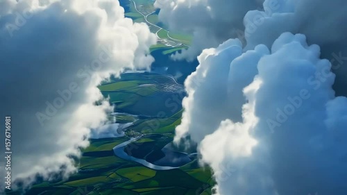Airplane flying above clouds over farmland during daylight