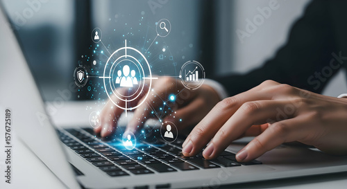 Hands typing on laptop with customer targeting icons, representing audience segmentation, digital marketing, CRM strategy, data analytics, personalization, and customer engagement in business. 