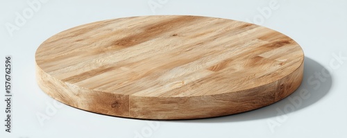 Large, round, light-brown wooden board with visible wood grain, thick edges, and a smooth surface