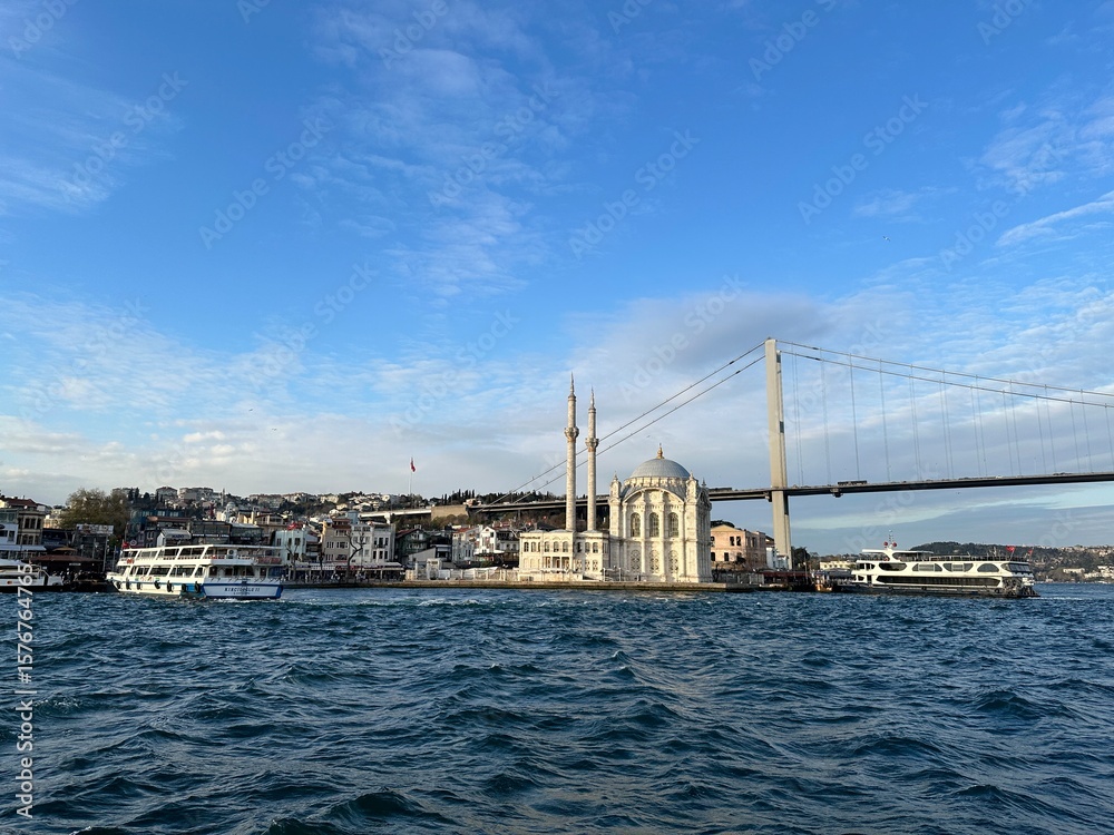 Naklejka premium Mosque on the water in Istanbul, Turkey during a Bosphorus River cruise