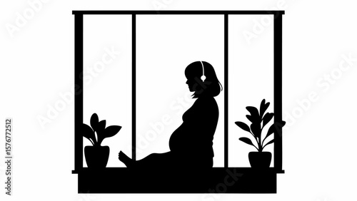 Silhouette of pregnant woman with headphones sitting by window with plants in pots in black and white