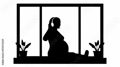 Silhouette of pregnant woman with headphones sitting by window with potted plants in black and white style