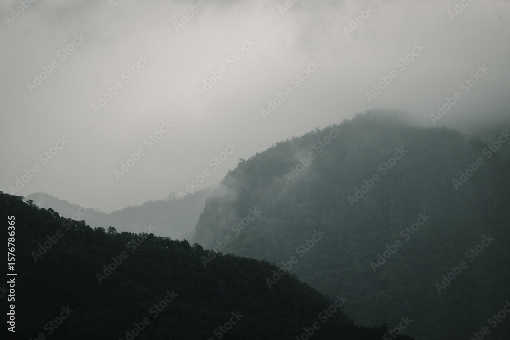 Fototapeta premium Fog slowly rising over the hills creating a mystical landscape