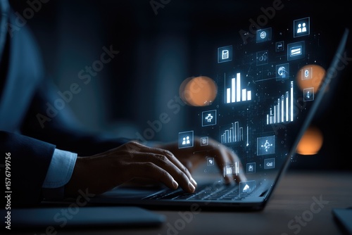 Person working on laptop, glowing data graphics overlay
