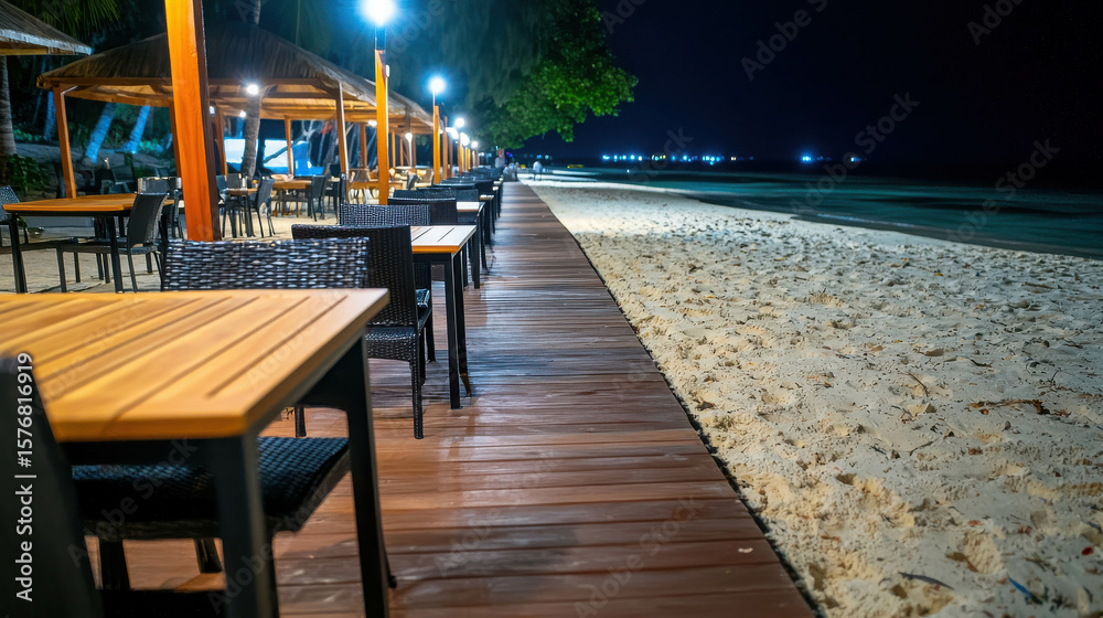 Fototapeta premium Serene Beachside Dining Under Stars with Wooden Pathway and Trees at Night, Peaceful Coastal Ambiance for Relaxation and Enjoyment