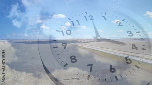 Plane starting ground roll over runway clock overlay showing minute hand sweeping for time lapse