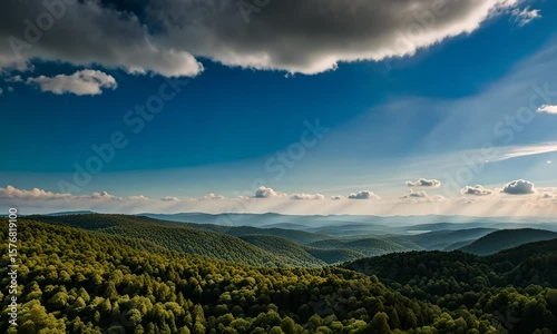 Beautiful sunset over the mountains with a fiery sky and wispy clouds in a peaceful rural landscape