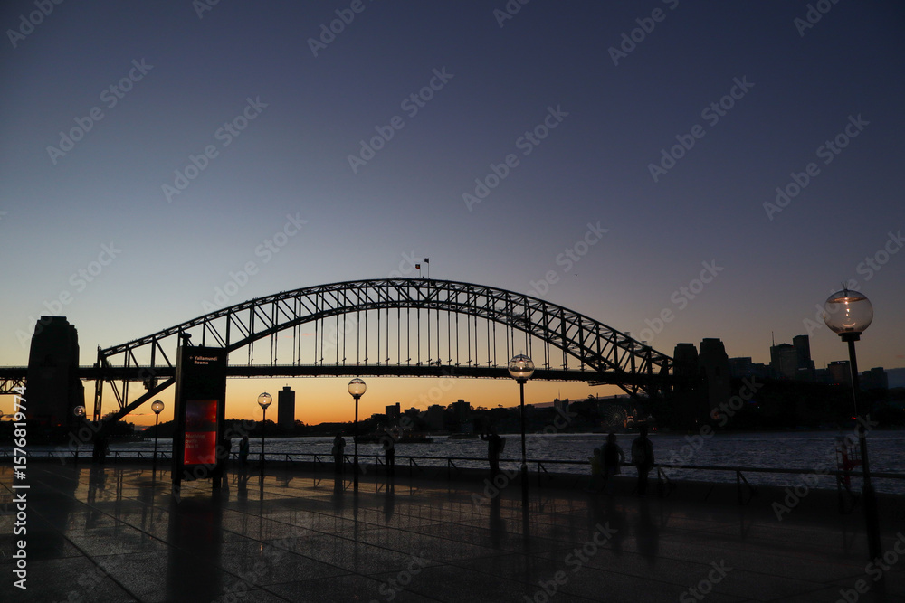 Naklejka premium sydney harbour bridge at sunset