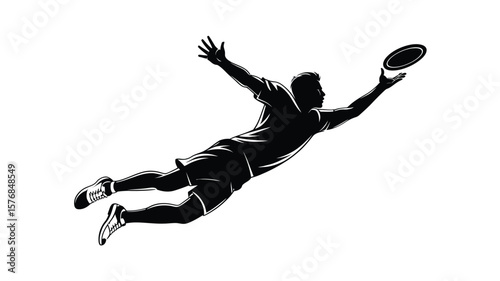 Silhouette of a man diving to catch a frisbee in mid air