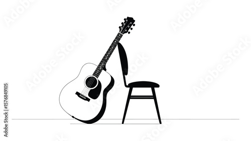 Acoustic guitar leaning against a simple chair on a white background