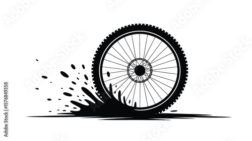 Black silhouette of a bicycle wheel splashing through mud and dirt