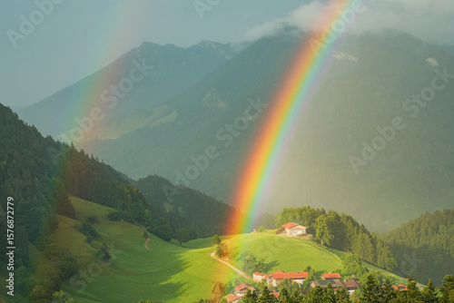 Double rainbow over a mountain landscape with a small mountain village in the Chiemgau Alps, Bavaria, Germany
