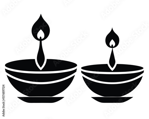 Two black and white traditional oil lamps diya suitable for religious celebrations. Diwali element.