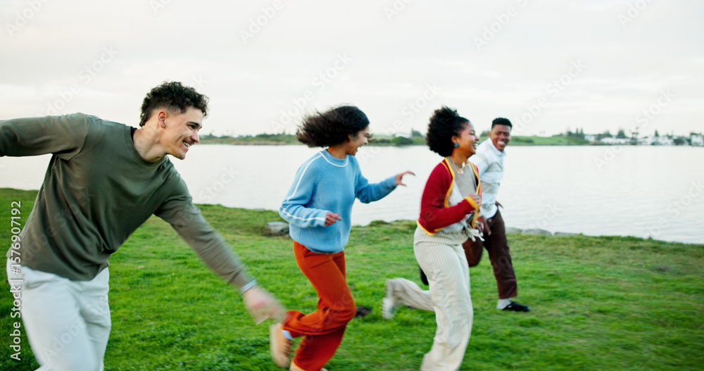 Obraz premium Holiday, friends and running outdoor at lake for bonding, excited students and adventure together. Man, woman and group race on vacation for travel, journey and happy with energy on gap year by park