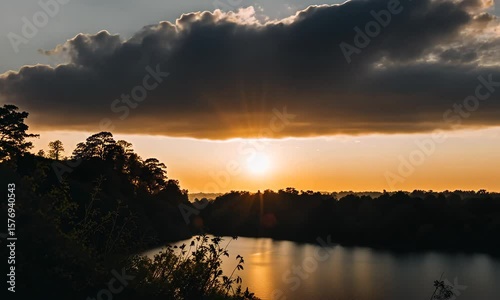 Golden sunset reflecting over calm river and lake
