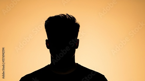 Escape exit minimalist. Silhouette of a person with short hair against a warm orange background, showing no facial features or details.