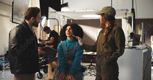 Behang Director, actress and makeup artist with production crew for instructions or preparation on set
