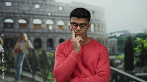 Photography Young man contemplating in front of the historic roman coliseum, outdoors in rom