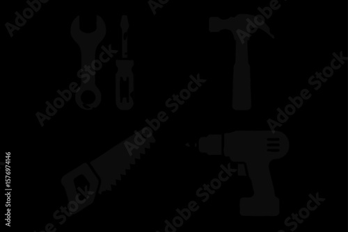 Silhouette of hand tools and power drill on black background