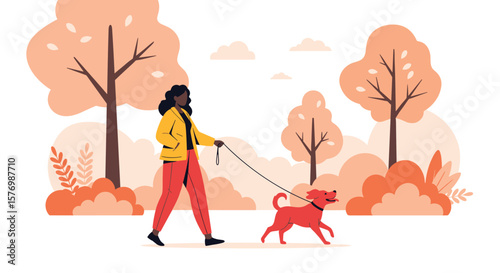 A woman walks her dog in a park during autumn with colorful trees and foliage creating a beautiful scene