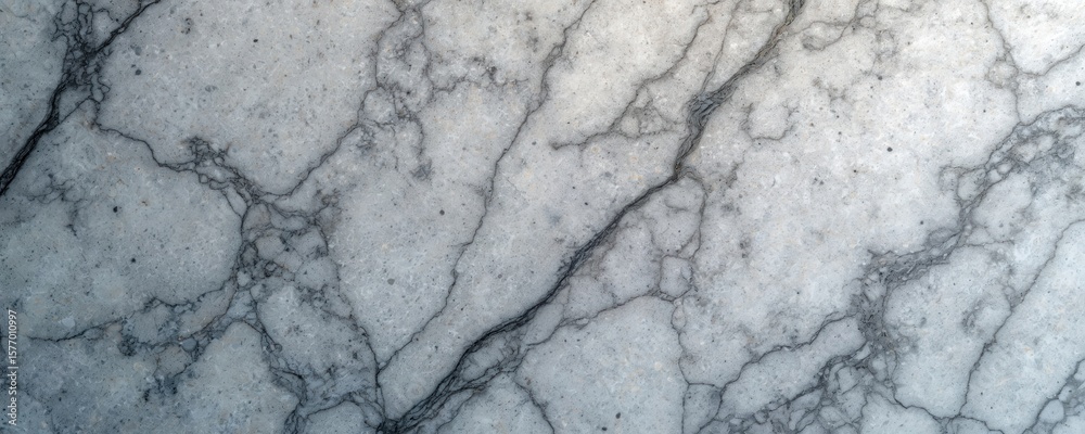 Fototapeta premium Close-up of dark grey marble countertop with uneven textured surface. Small cracks and lines on surface reveal material history. Rich, dark gray hue dominates surface.